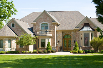 A spacious home set on a large grassy lawn.