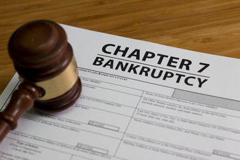 A gavel lying on top of Chapter 7 bankruptcy papers